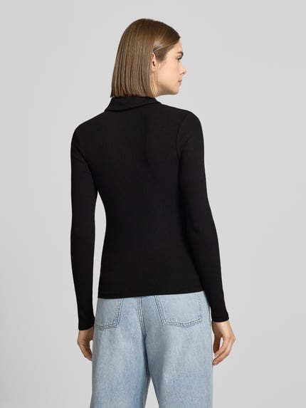 Frauenmodel trägt schwarzes, unifarbenes Slim Fit Langarmshirt aus Baumwoll-Mix Modell 'KITTE' von Pieces mit Rippstruktur, Ganzkörperansicht Rückansicht.