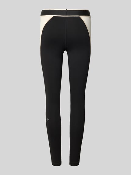 Produktfoto, schwarze Slim Fit Leggins mit elastischem Bund Modell 'MALBON' von Fabletics, beige Einsätze, glatte Textur, Knöchellänge