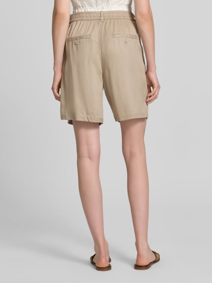 Kobiece modelka nosi Regular Fit Bermudas aus Lyocell od Tom Tailor, jednolity beż, delikatna struktura, widok całej sylwetki z tyłu.