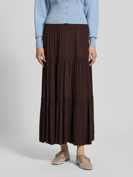 Vrouwenmodel draagt uitlopend dames maxirok van Only, model 'Mikka', look: effen, volants, kreuklook, zuiver viscose, maxilengte. Nahaufnahme onderlichaam.