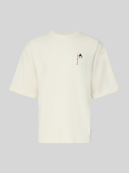 Produktfoto, T-Shirt mit Label-Detail Modell 'Beam' von WOODBIRD aus reiner Bio-Baumwolle in Creme mit geripptem Rundhalsausschnitt, lockerer Schnitt.