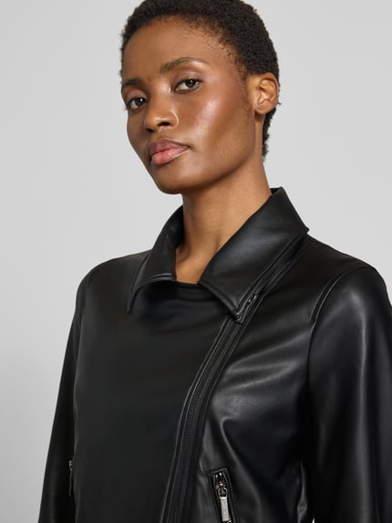 Frauenmodel trägt Jacke in Leder-Optik von Armani Exchange in Schwarz mit Reverskragen und Zweiwege-Reißverschluss, Nahaufnahme Oberkörper, taillierte Passform, Reißverschlusstaschen, Rückenlänge 57 cm, Schulterbreite 39 cm, Brustweite 47 cm, Ärmellänge 60 cm.