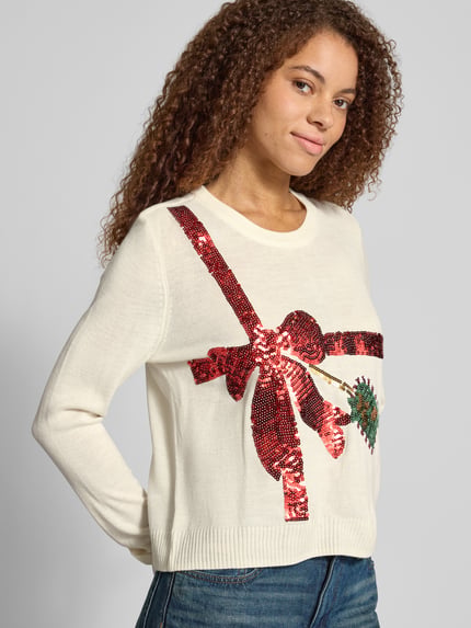 Frauenmodel trägt Rollkragenpullover mit weihnachtlichem Motiv-Print von ONLY, mehrfarbig, Strickoptik, Nahaufnahme Oberkörper.