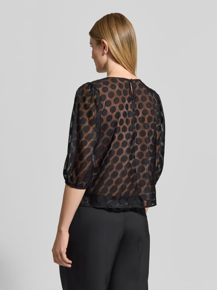 Frauenmodel trägt Semitransparentes Blusenshirt im Allover-Look von Christian Berg Woman Selection, schwarz mit Punktemuster, Ganzkörperansicht Rückansicht. Material-Mix mit Viskose-Anteil, Regular Fit, 3/4-Arm.