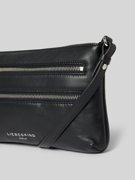 Produktfoto, Shoulder Bag mit Logo-Print Modell 'Zena' von LIEBESKIND BERLIN in Schwarz, Glattleder, zwei silberne Reißverschlussfächer, schmaler Schulterriemen, Hauptfach mit Reißverschluss, strukturierte Oberfläche, Maße 26x15x4 cm, Schulterriemen 115 cm.