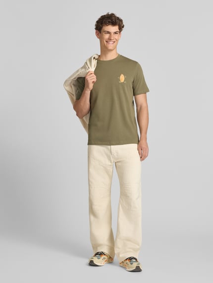 Männermodel trägt Herren T-Shirt mit Stitching Modell 'SUN ISLAND' von Blend in Olive, Reine Baumwolle, Regular-Fit, Ganzkörperansicht von vorne.