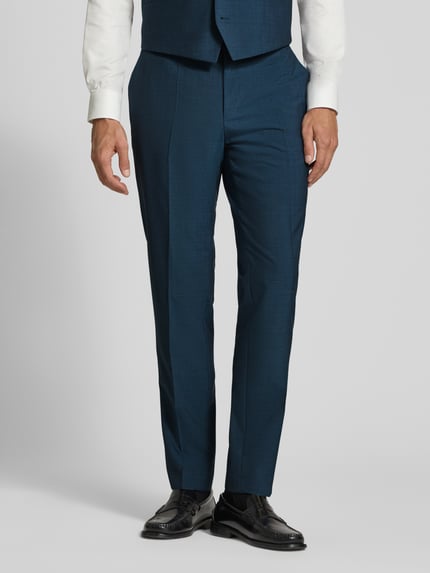 Männermodel trägt Regular Fit Anzug aus Wolle mit Bundfalte von HUGO in Dunkelblau, feines Webstruktur, Nahaufnahme Unterkörper, klassische Passform.