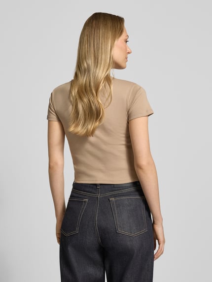 Frauenmodel trägt Slim Fit T-Shirt aus Baumwoll-Mix Modell 'DELANOR' von HUGO, Optik: Unifarben, Ganzkörperansicht Rückansicht.