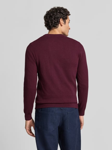 Männermodel trägt Strickpullover aus Baumwoll-Kaschmir-Mix mit Rundhalsausschnitt von MCNEAL in Dunkelrot, Ganzkörperansicht Rückansicht, Regular Fit, Rückenlänge 70 cm, Ärmellänge 74 cm.
