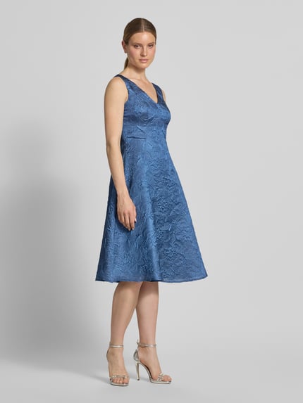 Vrouwenmodel draagt Cocktailkleid met Strukturmuster en V-Ausschnitt van Vera Mont in A-lijn, midilengte, blauwe tinten, Ganzkörperansicht van voren.