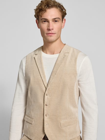 Männermodel trägt Weste aus Cord mit Pattentaschen von MCNEAL in Beige, Regular Fit, V-Ausschnitt, Nahaufnahme Oberkörper, Rückenlänge 60 cm bei Größe 50.