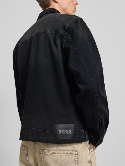 Männermodel trägt schwarze Regular-Fit Jeansjacke aus Baumwoll-Mix Modell 'LUNEY BO REF' von BOSS Orange, Rückansicht