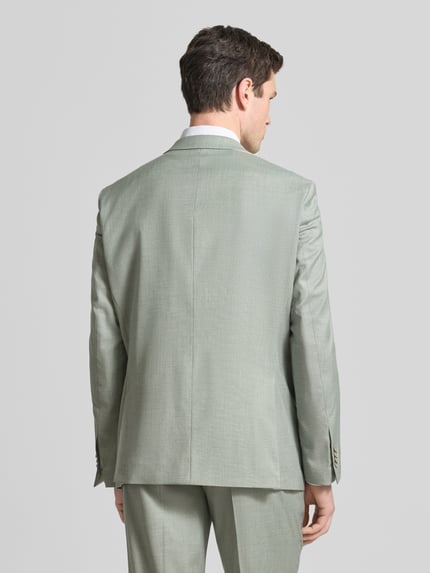 Männermodel trägt Straight Fit Blazer mit viscose van Christian Berg Men in lichtgrijs, elastische materiaalmix, borstzak, reverskraag, 2-knoopsluiting, klepzakken, ruglengte maat 50: 76 cm, schouderbreedte: 49 cm, mouwlengte: 68 cm. Ganzkörperansicht Rückansicht.