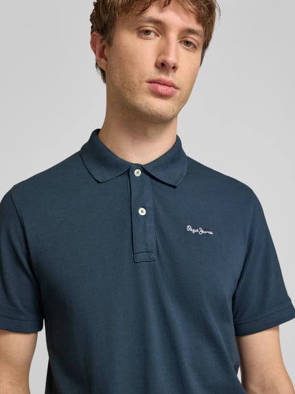 Männermodel trägt Regular Fit Poloshirt aus reiner Baumwolle Modell 'OSCAR' von Pepe Jeans, Optik: Unifarben, Nahaufnahme Oberkörper.