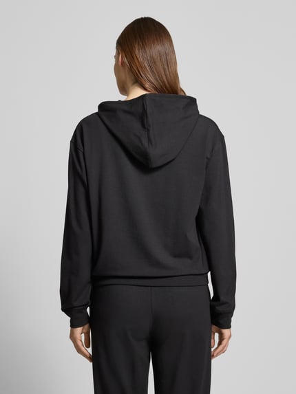 Vrouwenmodel draagt Regular Fit Hoodie uit katoen-modal-mix model 'SIGNATURE' van HUGO, effen zwart met labelstiksel, rugaanzicht.