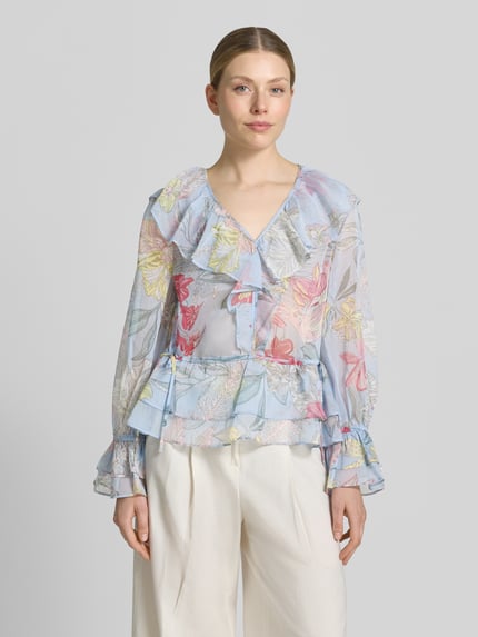 Vrouwenmodel draagt Regular Fit Bluse mit Volants und Trompetenärmeln van comma, lichte kleuren, all-over look, V-hals, volants, trompetmouwen, ruglengte maat 36: 57 cm, mouwlengte maat 36: 60 cm, vooraanzicht van het hele lichaam.