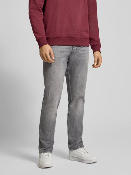 Männermodel trägt Straight Fit Jeans aus Baumwoll-Mix von Tommy Jeans in Melange-Optik mit 5-Pocket-Design, Ganzkörperansicht von vorne.