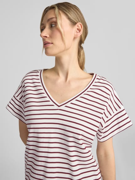 Frauenmodel trägt Relaxed Fit T-Shirt aus reiner Baumwolle von s.Oliver RED LABEL, weiß mit roten Streifen, Nahaufnahme Oberkörper.