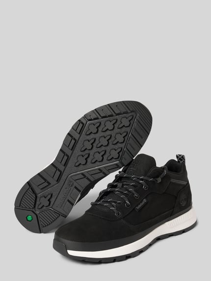 Produktfoto, Sneaker aus Leder-Mix von Timberland in Schwarz mit abgerundeter Form, strukturiertem Schnürverschluss und Label-Detail, strukturierte Sohle, Absatzhöhe 3 cm, Schafthöhe 9 cm, Schaftweite 10 cm.