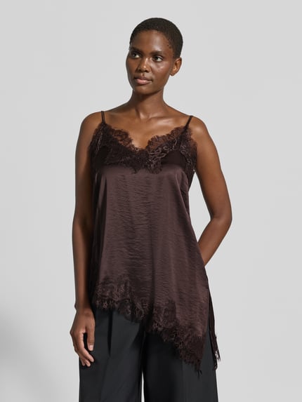 Frauenmodel trägt Regular Fit Top mit Viskose-Anteil Modell 'Dove' von FREE/QUENT, braun, Spitzenbesatz, asymmetrisch, Nahaufnahme Oberkörper.
