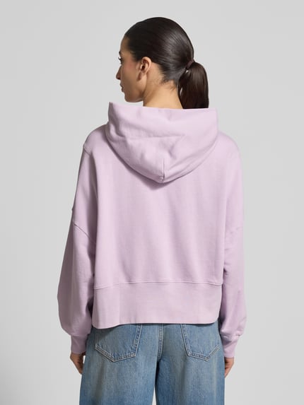 Modelka nosi Relaxed Fit Hoodie aus reiner Baumwolle von Marc O'Polo, efekt: jednolity kolor, dzianina dresowa, nadruk z logo, kaptur, długi rękaw, prążkowane wykończenie, wykończenie: dół, aplikacja, bawełna; widok całej sylwetki z tyłu.