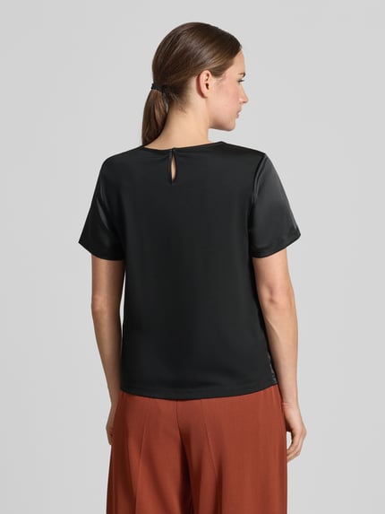 Frauenmodel trägt Regular Fit T-Shirt aus Satin Modell 'GILBERT' von Weekend Max Mara in Schwarz, glänzende Optik, Ganzkörperansicht Rückansicht.