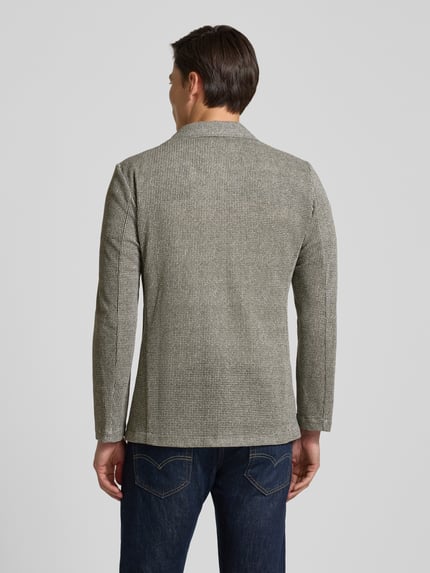 Männermodel trägt Slim Fit 2-Knopf-Sakko mit Reverskragen von Zuitable, Baumwoll-Mix, Strukturmuster, Rückansicht Ganzkörperansicht