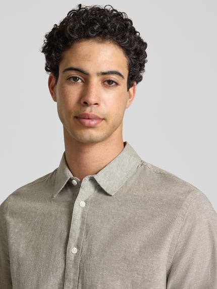 Männermodel trägt Regular Fit Freizeithemd mit Kentkragen Modell 'ABAN' von Blend, Halbarm, feine Textur, Nahaufnahme Oberkörper.