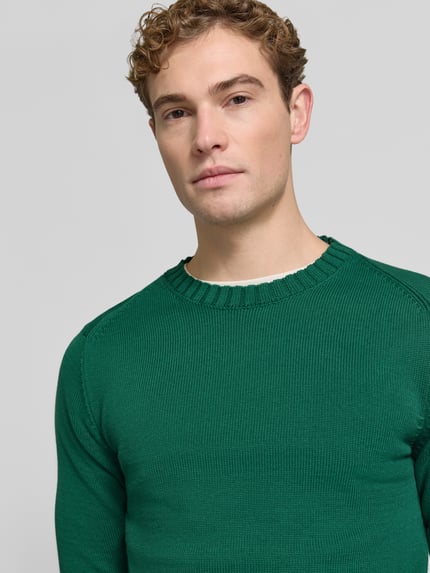 Männermodel trägt Pullover mit markanten Teilungsnähten von S.OLIVER CASUAL, grün, Strukturstrick, Rundhals, Nahaufnahme Oberkörper.