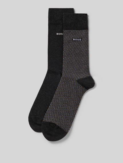 Produktfoto, Socken mit Label-Detail im 2er-Pack von BOSS aus Baumwoll-Mix mit Stretch-Anteil, elastische Rippenbündchen, ein Paar in Schwarz, ein Paar mit feinem Muster und Label-Detail.