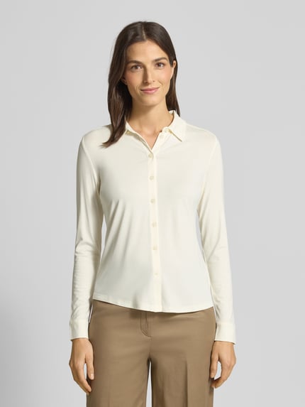 Vrouwenmodel draagt Hemdbluse aus Viskose-Mix mit Umlegekragen van Marc O’Polo, effen crème, lange mouwen, rechte pasvorm, voorkant, bovenlichaam.