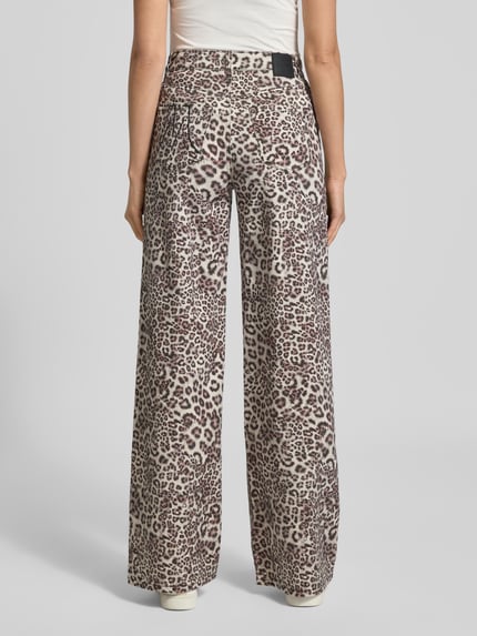 Männermodel trägt Wide Fit Jeans mit Allover-Animal-Print von Marc Cain, elastyczna mieszanka bawełny, 5 kieszeni, zapięcie na guzik i zamek, szerokość w rozmiarze 36: 37 cm, długość wewnętrzna nogawki: 83 cm, widok całej sylwetki z tyłu