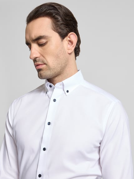 Männermodel trägt Regular Fit Business-Hemd mit Button-Down-Kragen von OLYMP, Reine Baumwolle, Unifarbenes-Design, Nahaufnahme Oberkörper.