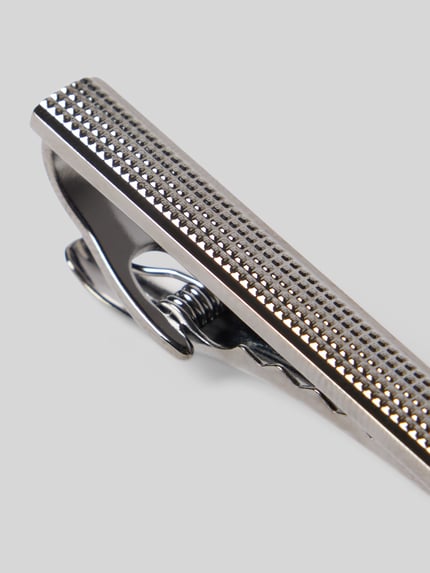 Produktfoto, Krawattenklammer inkl. Aufbewahrungsbox von Lindenmann aus Metall im rechteckigen Design mit Strukturmuster auf grauem Hintergrund