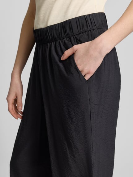 Vrouwenmodel draagt Loose Fit Culotte uit viscose-mix van s.Oliver RED LABEL, uni, elastische tailleband, zijzakken, popeline. Detailopname heup.