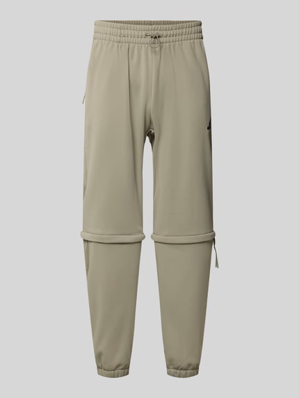 adidas Sportswear Spodnie dresowe o kroju relaxed fit z nadrukiem z logo Trzcinowy 2