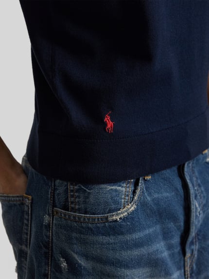 Vrouwenmodel draagt 'Regular Fit Stricktop aus Baumwoll-Mix' van Polo Ralph Lauren in uni donkerblauw fijngebreid katoenmix, logostiksel, mouwloos, ribboord, close-up taille.