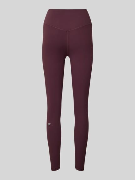 Produktfoto, schlanke Damen Leggins in Dunkelrot mit elastischem Bund und kleinem Logo-Print, Slim Fit Leggins mit Logo-Print Modell 'PURELUXE' von Fabletics, glatte Textur