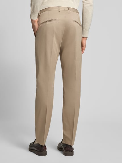 Männermodel trägt Stoffhose mit Gesäßtaschen Modell 'Tenuta' von Tiger Of Sweden, beige Baumwoll-Elasthan-Mix, Ganzkörperansicht Rückansicht