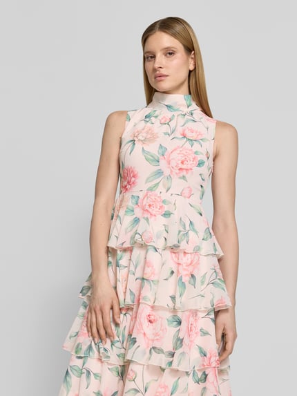 Modelka damska nosi tailliertes Freizeitkleid mit Volants Modell 'FELICIA' od Vero Moda, kolorowy, wzór kwiatowy, szyfon, długość midi, krój slim fit, widok całej sylwetki z przodu