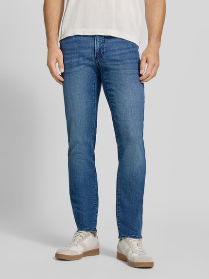 Männermodel trägt Modern Fit Jeans aus katoenmix Model 'Chuck' van Brax in denimlook, 5-pocketmodel, lichte wassing, twillstructuur, labelpatch en labeldetail, mid waist, knoop- en ritssluiting, riemlussen, Ganzkörperansicht van voren.