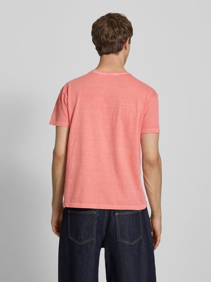 Männermodel trägt T-Shirt aus Baumwoll-Leinen-Mix mit Brusttasche von Superdry in Rosa, strukturierte Oberfläche, Regular-Fit, Rückenlänge 66 cm bei Größe M, Ganzkörperansicht Rückansicht.