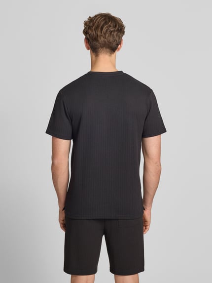 Männermodel trägt Regular Fit T-Shirt mit Viskose-Anteil Modell 'TREY' von Only & Sons, Optik: Unifarben, Struktur, Ganzkörperansicht Rückansicht.