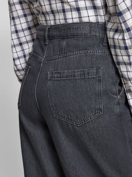 Frauenmodel trägt Jeans mit französischen Eingrifftaschen von Smith and Soul, Reine Baumwolle, Lockerer-Schnitt, Gesäßtaschen, Knopf-Reißverschluss, Nahaufnahme Rückansicht.