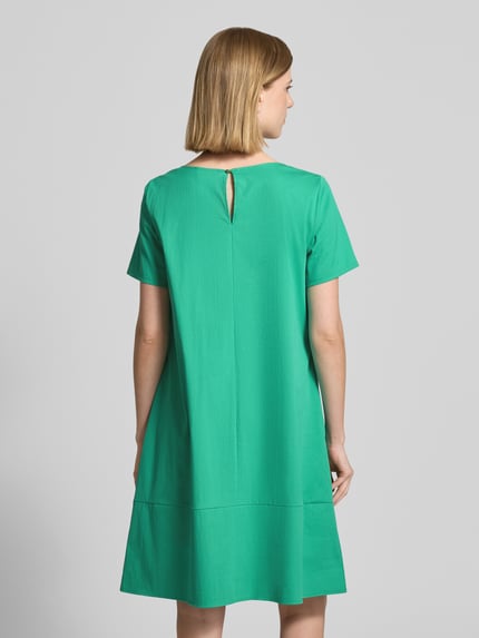 Modelka nosi sukienkę mini z zapięciem na guzik z tyłu od ROBE LÉGÈRE, zielona mieszanka bawełny z dodatkiem streczu, linia a, okrągły dekolt, długość tyłu w rozmiarze 36: 90 cm, szerokość w rozmiarze 36: 48 cm, długość rękawów w rozmiarze 36: 22 cm, gładka faktura, widok całej sylwetki z tyłu.