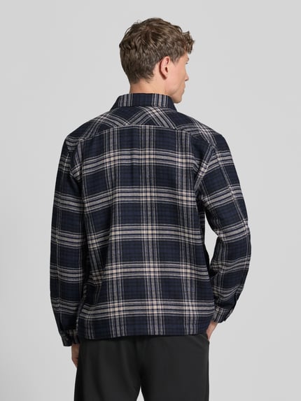 Männermodel trägt Hemdjacke mit durchgehender Knopfleiste von Selected Homme, efekt: w kratę, matowy, wykończenie: tkanina, wykładany kołnierz, listwa guzikowa na całej długości, krój z długim rękawem, mankiet, zaokrąglone wykończenie, detale: guziki, kołnierz, szwy, karczek, bez kieszeni, widok całej sylwetki z tyłu
