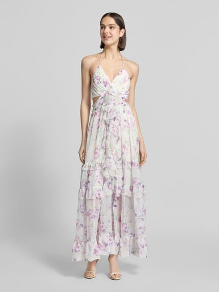 Frauenmodel trägt Regular Fit Midikleid mit Rüschenbesatz von ADLYSH mit floraler Allover-Print, V-Ausschnitt, Halterneck, Rückenausschnitt, Falten-Optik, fließende Stoffstruktur, sanfte Pastellfarben, Rückenlänge bei Größe S: 126 cm, Brustweite bei Größe S: 30 cm, Ganzkörperansicht von vorne.