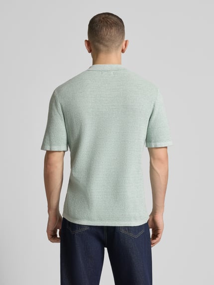 Männermodel trägt Regular Fit Poloshirt mit Strukturmuster Modell 'GEORGE' von Jack & Jones im Baumwoll-Mix, Rückansicht Ganzkörperansicht.