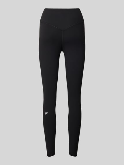Produktfoto, schwarze Slim Fit Leggins mit Logo-Print Modell 'PURELUXE' von Fabletics, elastischer Bund, glatte Textur, neutraler Hintergrund