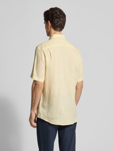 Männermodel trägt Regular Fit Freizeithemd aus Leinen von Christian Berg Men, hellgelb, Button-Down-Kragen, Ganzkörperansicht Rückansicht.